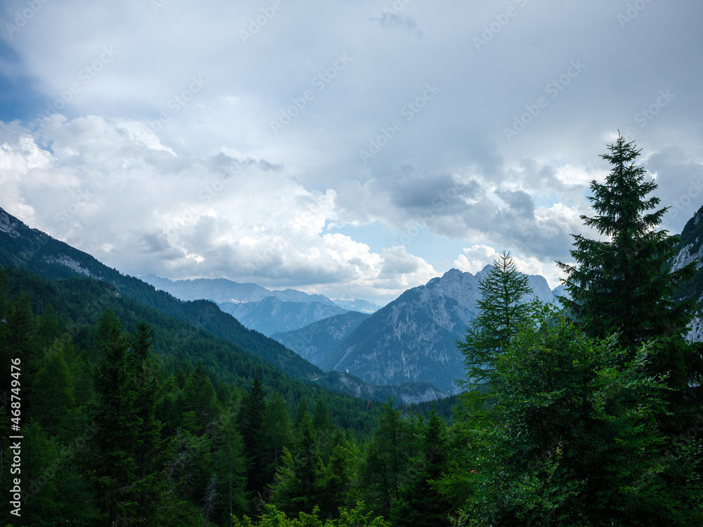 Fototapeta premium summer mountain tops and peaks under blue cloudy sky in Slovenia national Triglav park
