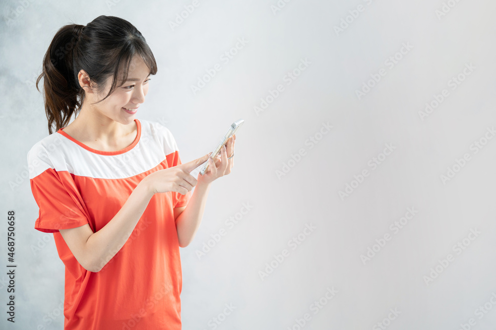 A beautiful Asian (Japanese) woman making a reservation at a gym. A beautiful Asian (Japanese) woman making a reservation at a gym.