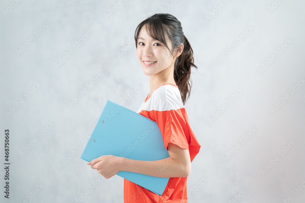Beautiful Asian (Japanese) woman looking like a gym instructor, looking at camera Beautiful Asian (Japanese) woman looking like a gym instructor, looking at camera