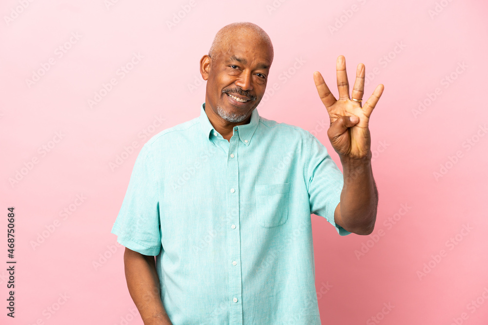 Cuban senior isolated on pink background happy and counting four with fingers Cuban senior isolated on pink background happy and counting four with fingers