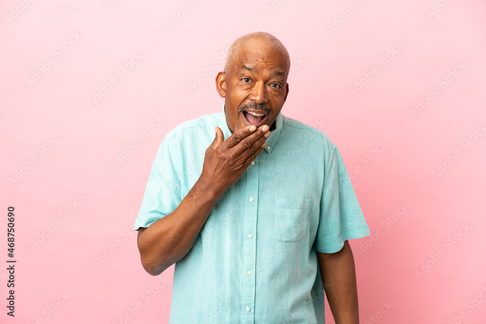 Cuban senior isolated on pink background happy and smiling covering mouth with hand Cuban senior isolated on pink background happy and smiling covering mouth with hand