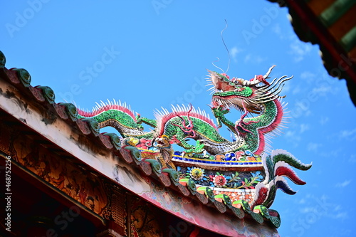 Longshan Temple, Taipei, Taiwan - November 11, 2021: Dragon-shaped Cochin pottery on the eaves of Longshan Temple.