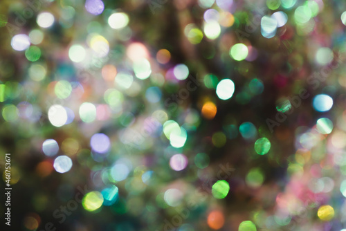 Beautiful natural bokeh of the colorful lights. Abstract Christmas New Year backdrop for text or advertising. Template for banner or party invitation