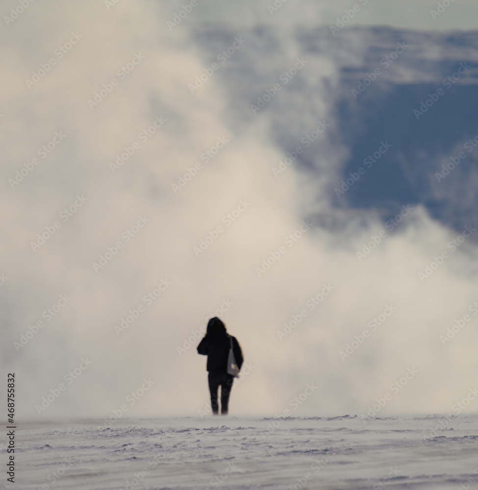 Unrecognizable woman silhouette walking into the smoke Unrecognizable woman silhouette walking into the smoke
