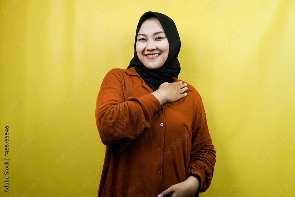 Beautiful and cheerful young asian muslim woman with hands holding chest isolated Beautiful and cheerful young asian muslim woman with hands holding chest isolated