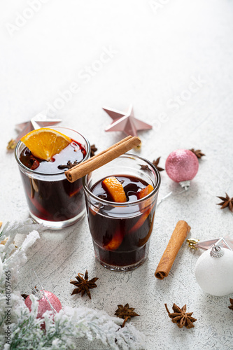 Two glass of mulled wine on light surface
