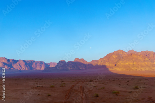 Cliffs and various rock formations  and the moon  Wadi Rum