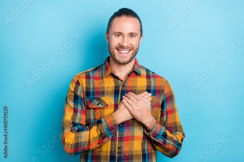 Photo of cute young brunette guy hands heart wear plaid shirt isolated on blue color background