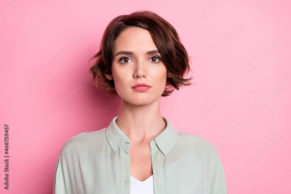Portrait of attractive calm content brown-haired girl wearing casual formal shirt isolated over pastel pink color background Portrait of attractive calm content brown-haired girl wearing casual formal shirt isolated over pastel pink color background