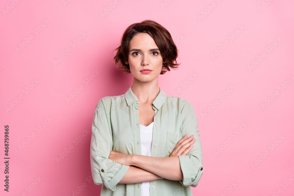 Portrait of attractive serious content brown-haired girl employee folded arms isolated over pastel pink color background Portrait of attractive serious content brown-haired girl employee folded arms isolated over pastel pink color background