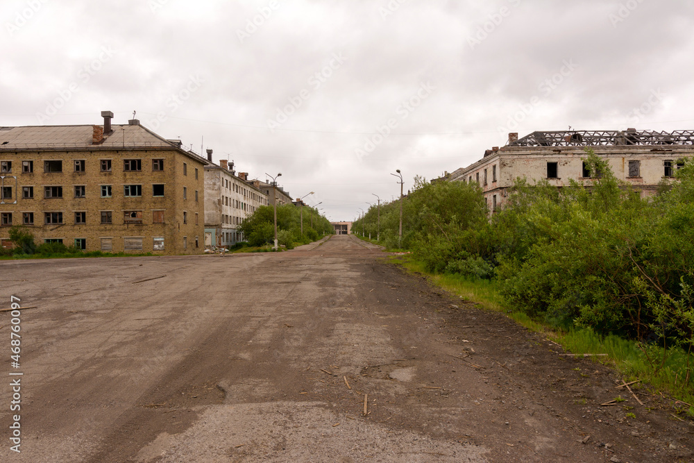 A deserted road leading to the ghost town of Sovetsky. Abandoned settlement. Russia.