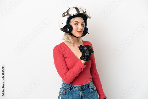 Young caucasian woman with a motorcycle helmet isolated on white background proud and self-satisfied © luismolinero