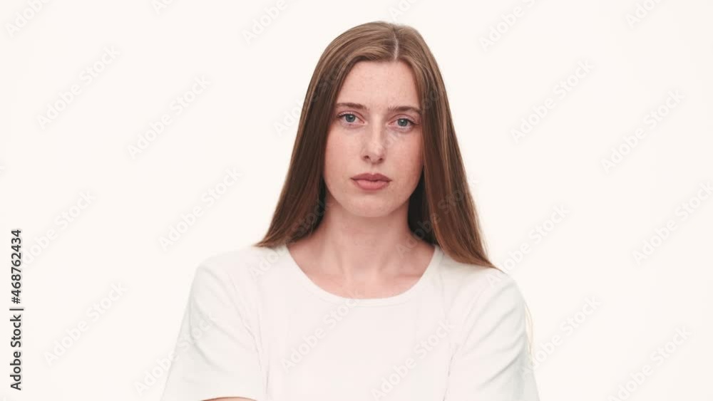Confident woman shaking her head positively and negatively in white studio Confident woman shaking her head positively and negatively in white studio
