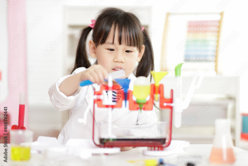 young girl plays colour mixing science experiment for home schooling young girl plays colour mixing science experiment for home schooling
