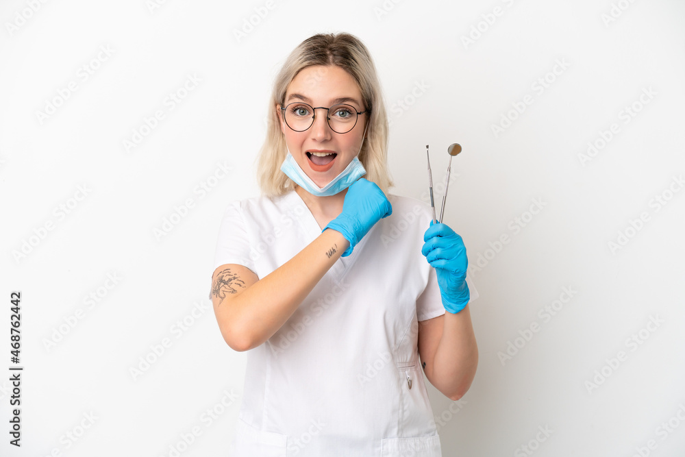 Dentist caucasian woman holding tools isolated on white background celebrating a victory Dentist caucasian woman holding tools isolated on white background celebrating a victory