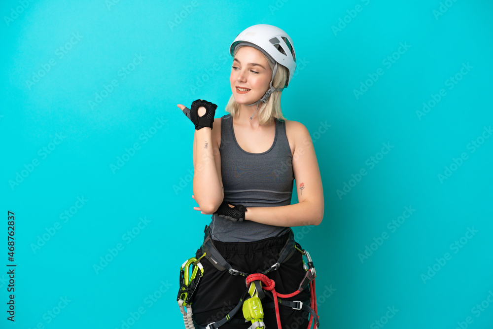 Young caucasian rock-climber woman isolated on white background pointing to the side to present a product Young caucasian rock-climber woman isolated on white background pointing to the side to present a product
