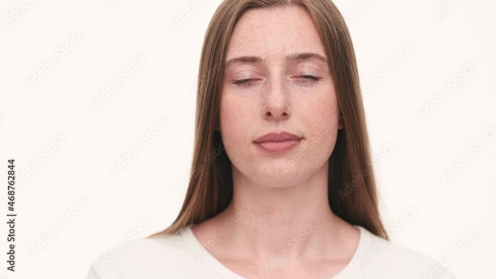 Portrait of handsome woman opening eyes at the camera in white studio Portrait of handsome woman opening eyes at the camera in white studio