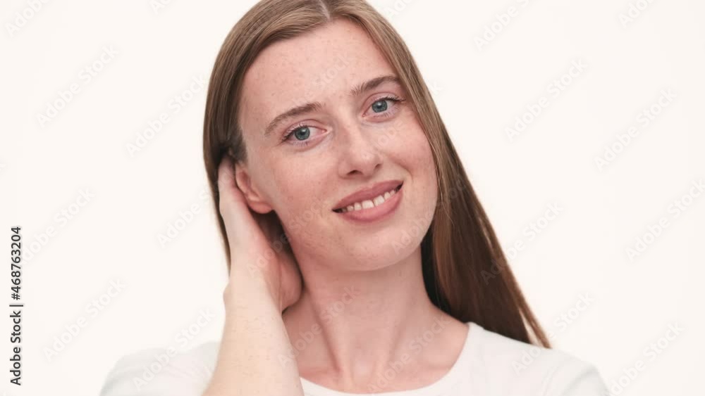 Portrait of positive woman posing at the camera in white studio Portrait of positive woman posing at the camera in white studio