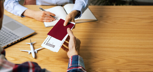 customer buying flight tickets in travel agency for his next trip