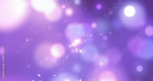 Image of christmas stars falling over lights and purple background