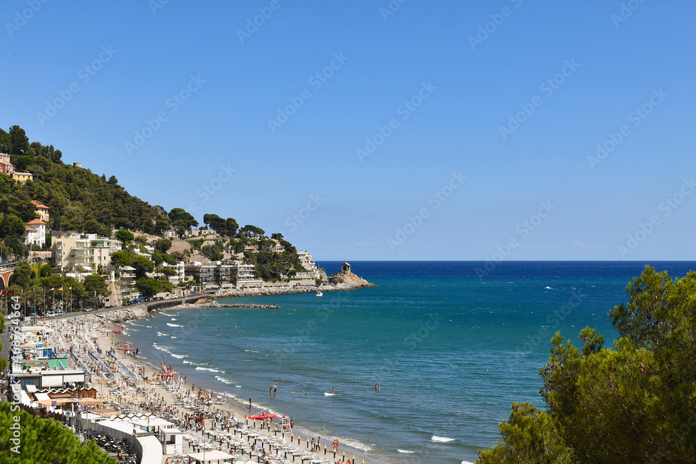 Panoramic view of the coastline with the promontory of Capo Santa Croce in a sunny summer day, Alassio, Savona, Liguria, Italy
