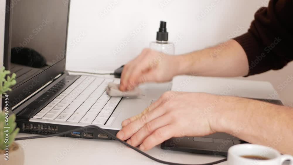 man cleans computer keyboard, a product and a napkin for washing screens. Technics and electronics, care. man cleans computer keyboard, a product and a napkin for washing screens. Technics and electronics, care.