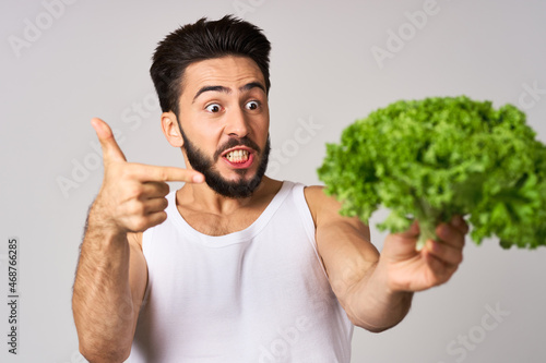bearded man in white t-shirt lettuce leaf vegetables healthy food