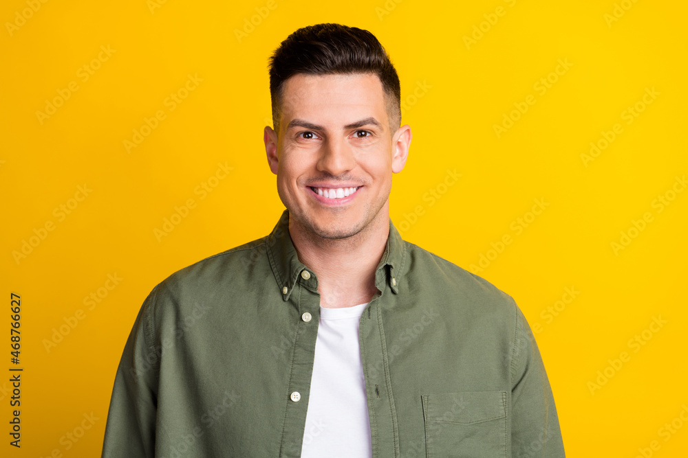 Photo portrait smiling man wearing shirt isolated bright yellow color background Photo portrait smiling man wearing shirt isolated bright yellow color background
