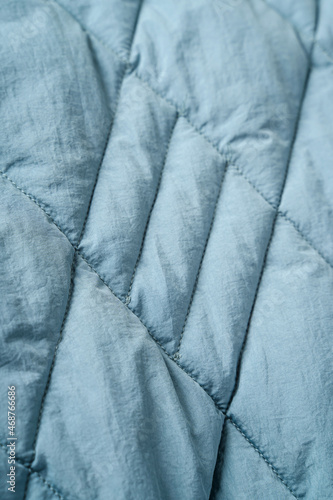 Quilted fabric background. Blue  texture blanket or puffer jacket