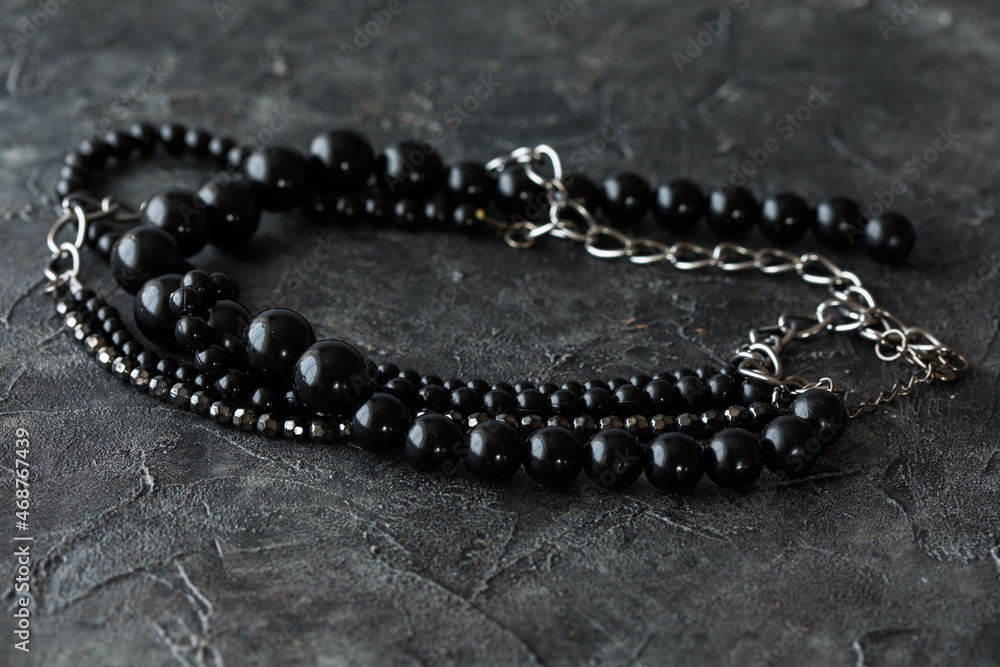 beads necklace on black table beads necklace on black table