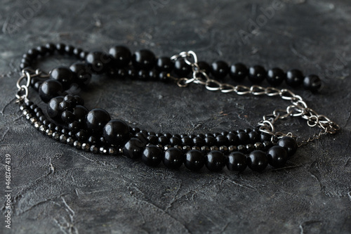  beads necklace on black table