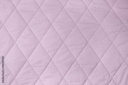 Quilted fabric background. lilac texture blanket or puffer jacket
