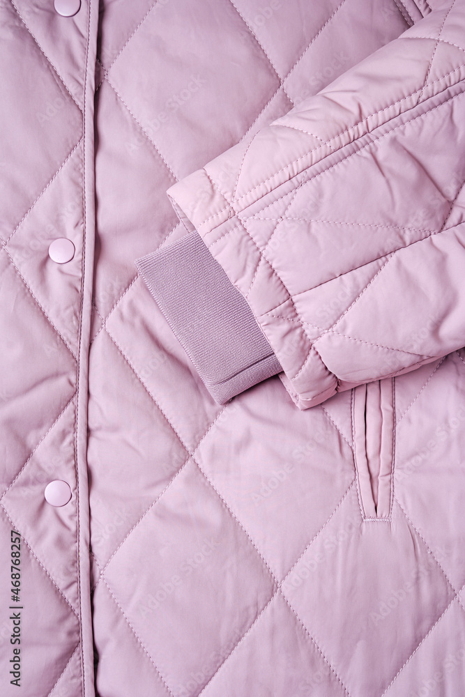 Obraz premium Close-up on lilac puffer jacket texture. Quilted fabric background