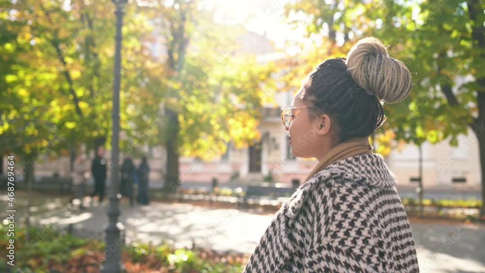 Close-up african american woman walking in an autumn park on a sunny day Close-up african american woman walking in an autumn park on a sunny day