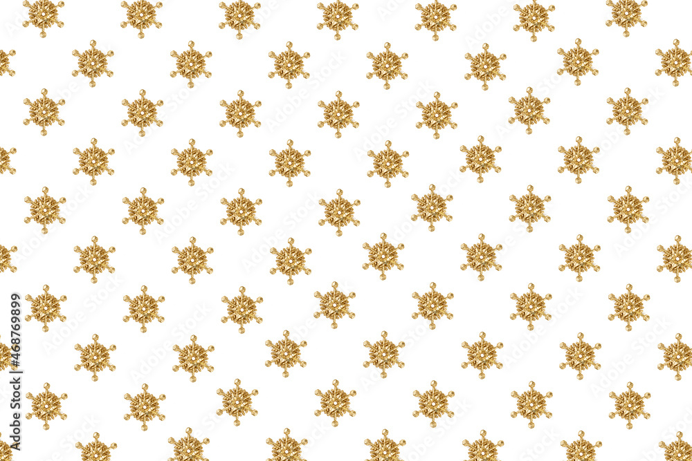 Pattern of golden snowflakes in the form of stars isolated on a white background diagonally. Background for Merry Christmas and Happy New Year greetings. Postcard, card. Copy space. Flat lay