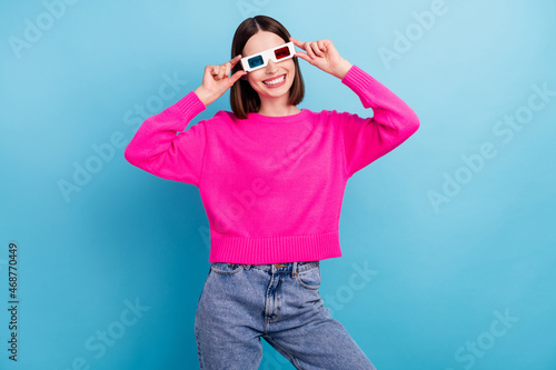 Photo of funky charming young lady wear pink pullover smiling arms vr glasses isolated blue color background © deagreez