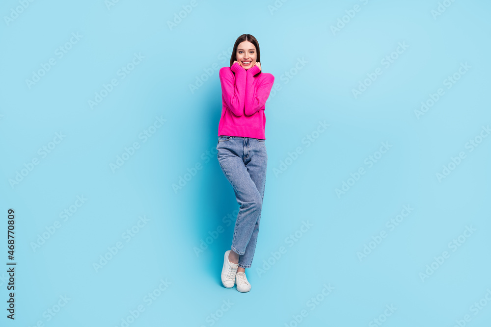 Full length body size view of attractive cheerful girl enjoying good mood posing isolated over bright blue color background Full length body size view of attractive cheerful girl enjoying good mood posing isolated over bright blue color background