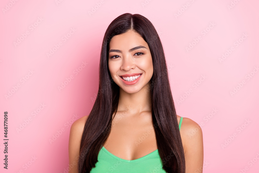 Photo of cute adorable young woman dressed green singlet smiling isolated pink color background Photo of cute adorable young woman dressed green singlet smiling isolated pink color background
