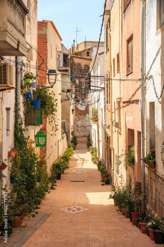 Narrow street through the buildings in Tortosa, Spain photo