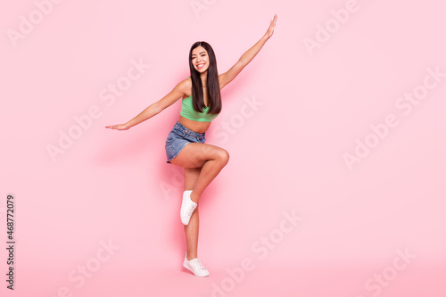 Photo of funky fooling young woman hair dressed green singlet smiling dancing isolated pink color background
