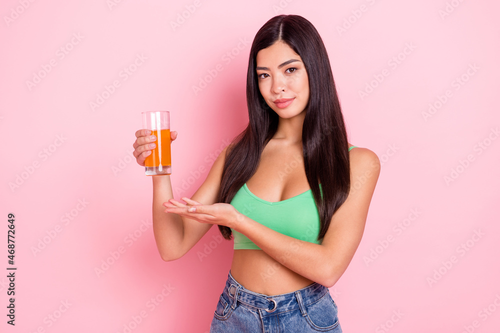 Photo of pretty adorable young woman hair dressed green singlet holding juice isolated pink color background Photo of pretty adorable young woman hair dressed green singlet holding juice isolated pink color background