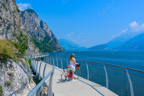 "Ciclopista del Garda" - Bicycle road and foot path over Garda lake with beautiful landscape scenery at Limone Sul Garda - travel destination in Brescia, Italy