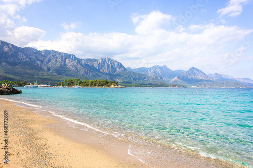 Seascape: clear blue sky, turquoise sea and mountains on the shore. Coastline of Kemer, Turkey.