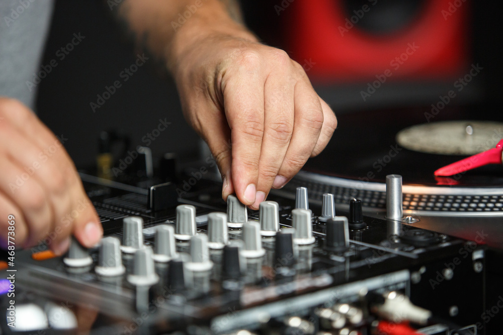 Hands of dj playing music in night club on party Hands of dj playing music in night club on party