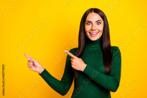 Photo of nice impressed brunette long hairdo lady point empty space wear green sweater isolated on bright yellow color background © deagreez