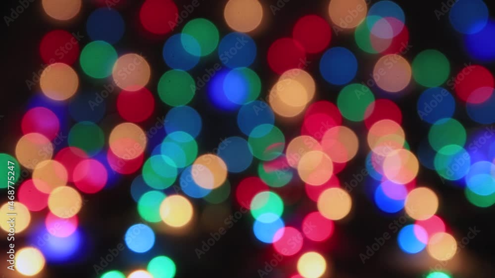 Multi-colored lights flickering on a black background, copy space. Greeting card for Christmas, New Year, Birthday. Festive video for intro, transition, splash screen. Copy space. UHD 4K. Multi-colored lights flickering on a black background, copy space. Greeting card for Christmas, New Year, Birthday. Festive video for intro, transition, splash screen. Copy space. UHD 4K.