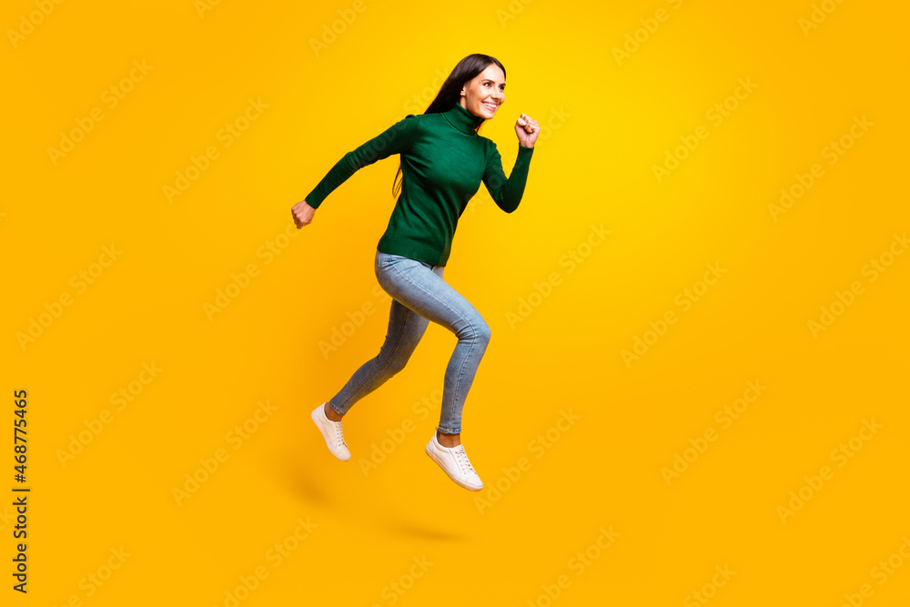 Full size profile side photo of cute nice cheerful lady jump up run empty space sale isolated on yellow color background