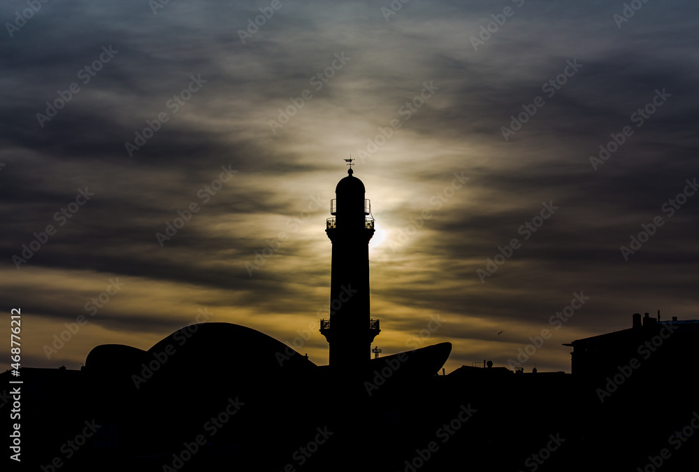 Lighthouse silhouette at sunset