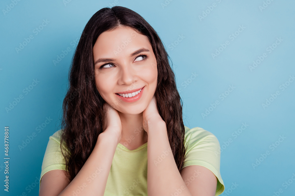 Photo of charming adorable lady hand neck imagine thoughts look blank space dream on blue wall Photo of charming adorable lady hand neck imagine thoughts look blank space dream on blue wall