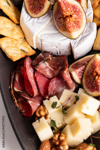 Assorted cheese, prosciutto, nuts, snacks and fruits